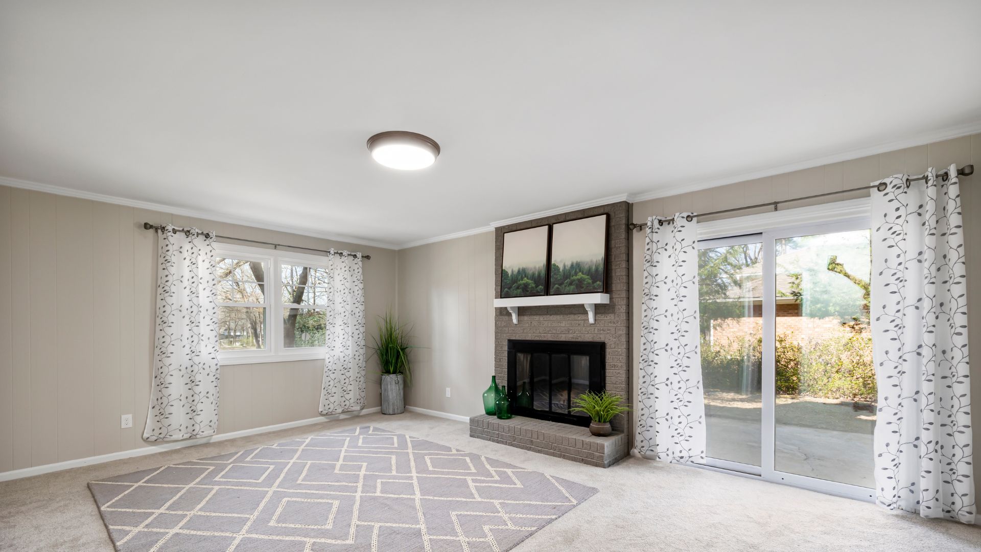 A living room with a fireplace and sliding glass doors