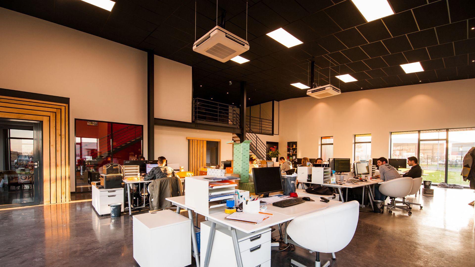 A group of people sitting at desks in a room